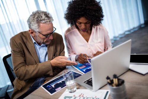 two coworkers using computer at work with network security configured